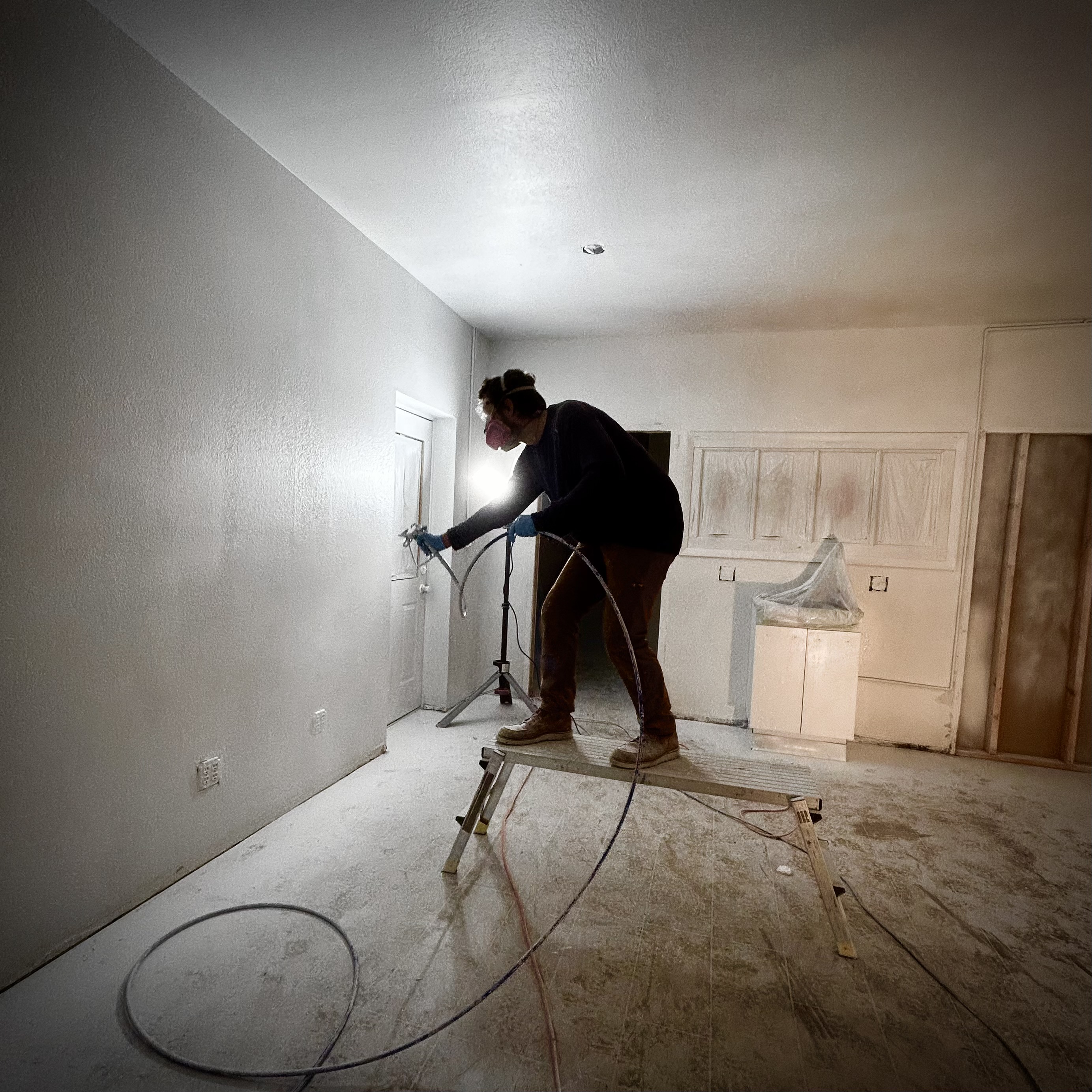 Cody painting the classroom with primer